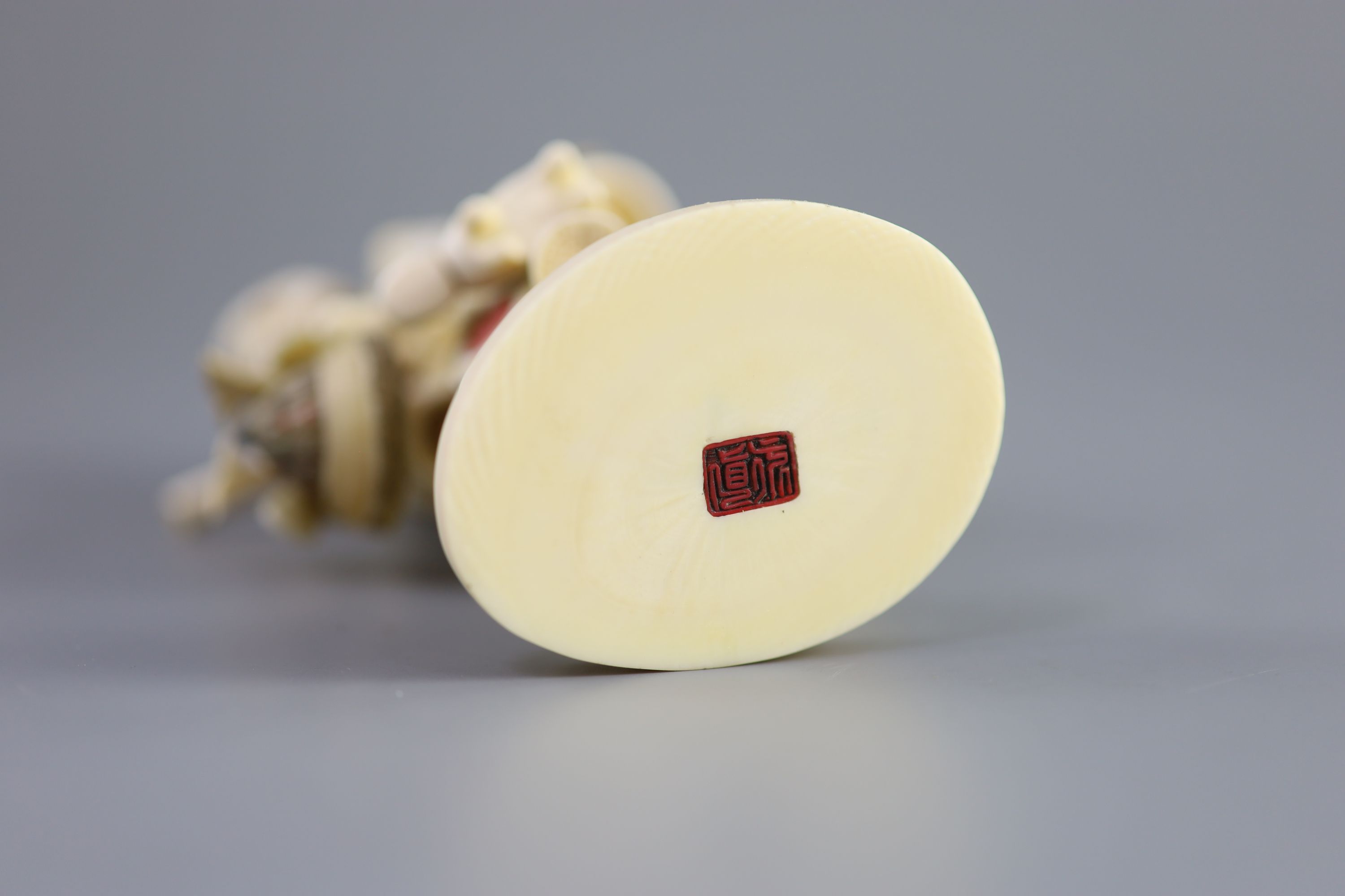 A Japanese ivory okimono of a basket seller, early 20th century 14.5 cm high